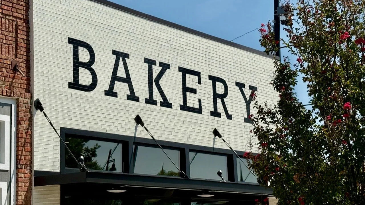 Bakery storefront with 'BAKERY' sign on a brick building